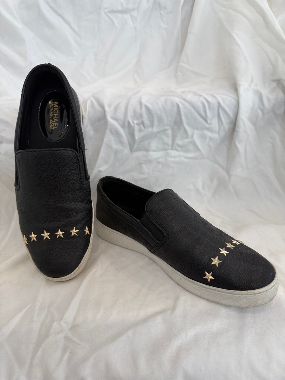 Michael Kors Black Slip-On Sneakers with Gold Star Accents